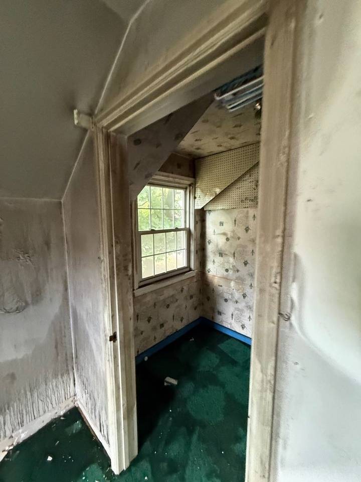 Soot-covered doorway and alcove after a fire