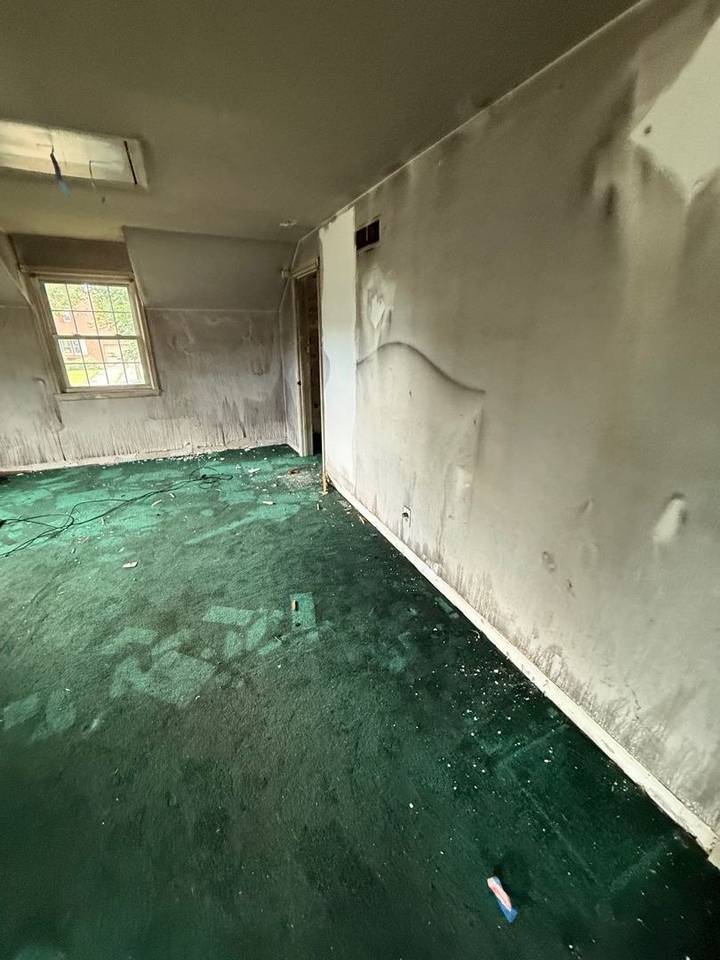 Bedroom wall blistered and darkened by smoke after a fire